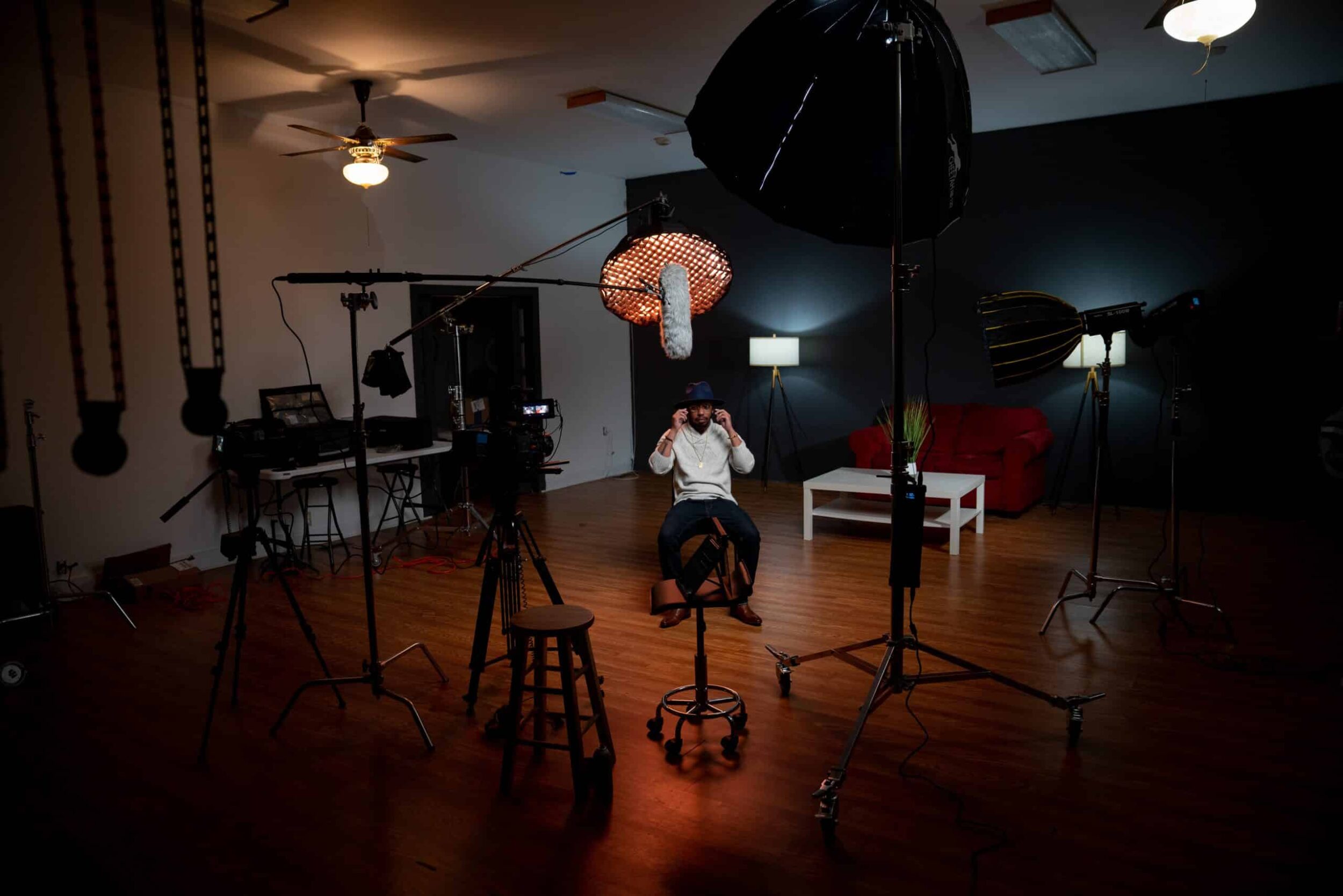Man sitting in video recording studio with blackmagic equipment as a cinematographer