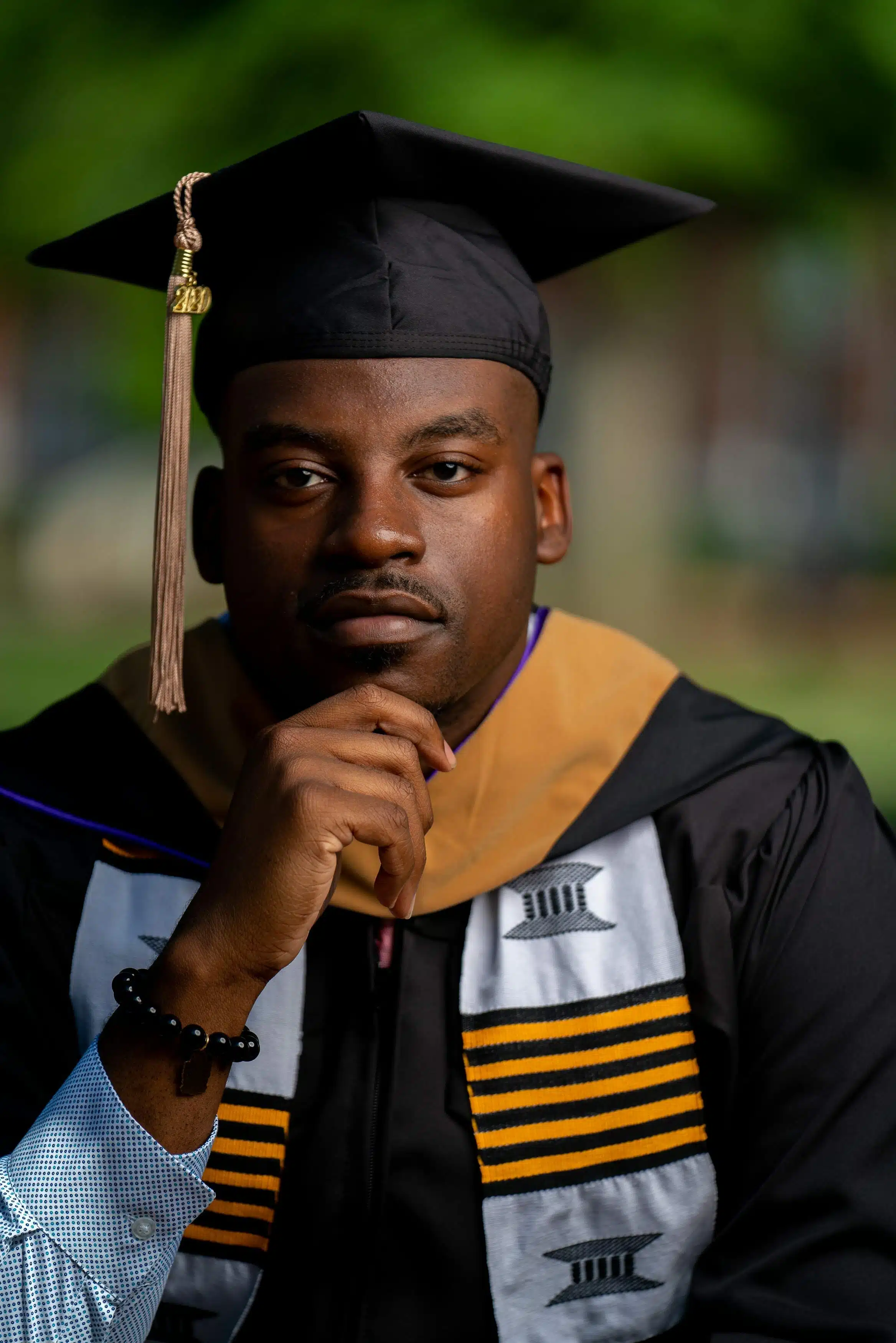 Young male graduate poses in cap and gown Stock Photo - Alamy